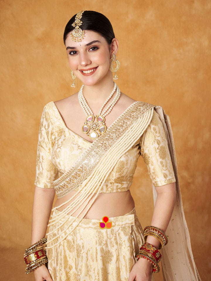 anokherang Lehenga Ivory Gold Banarsi Silk Lehenga Choli with Pearl Hand Embroidered Net Dupatta